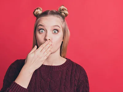 Lady holding arm on lips